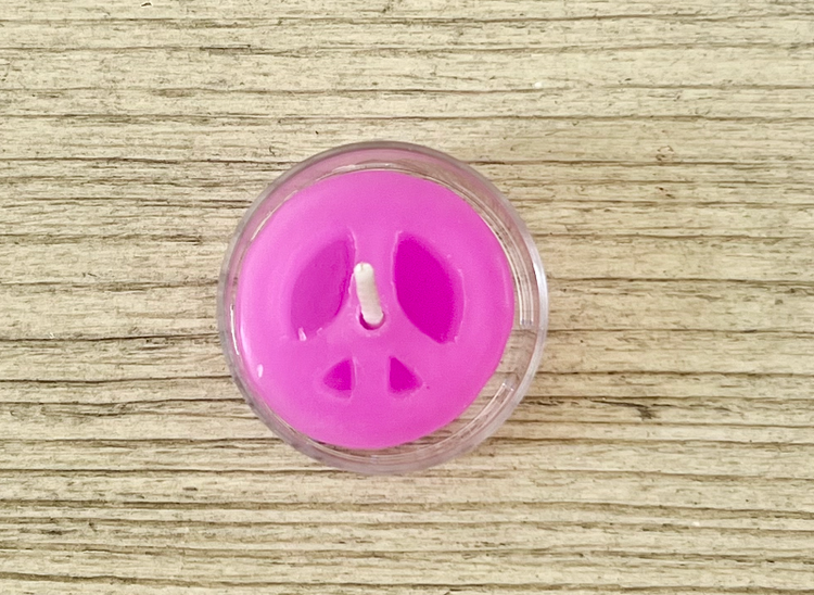 Pink peace sign candle